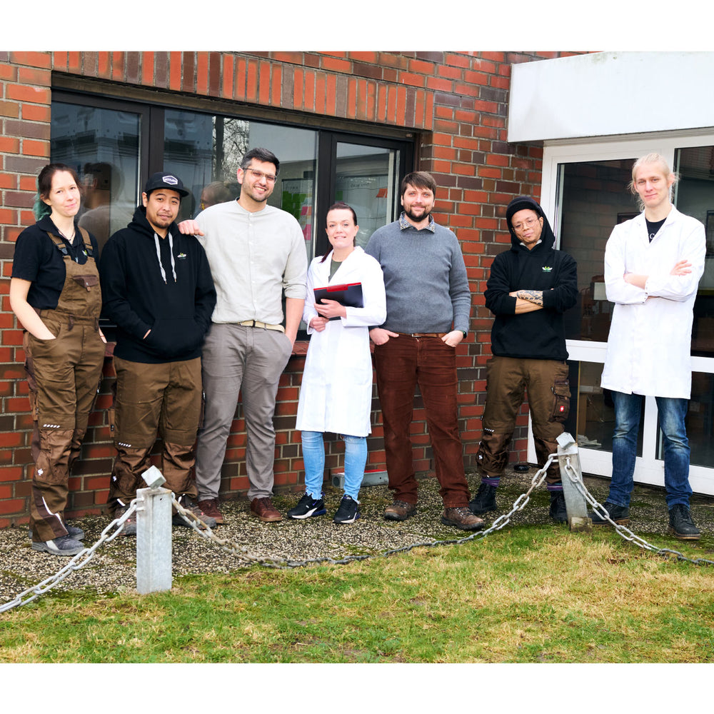 Foto des 7-köpfigen EntoSus-Teams vor dem Gebäude, in dem sich die Grillenfarm befindet.
